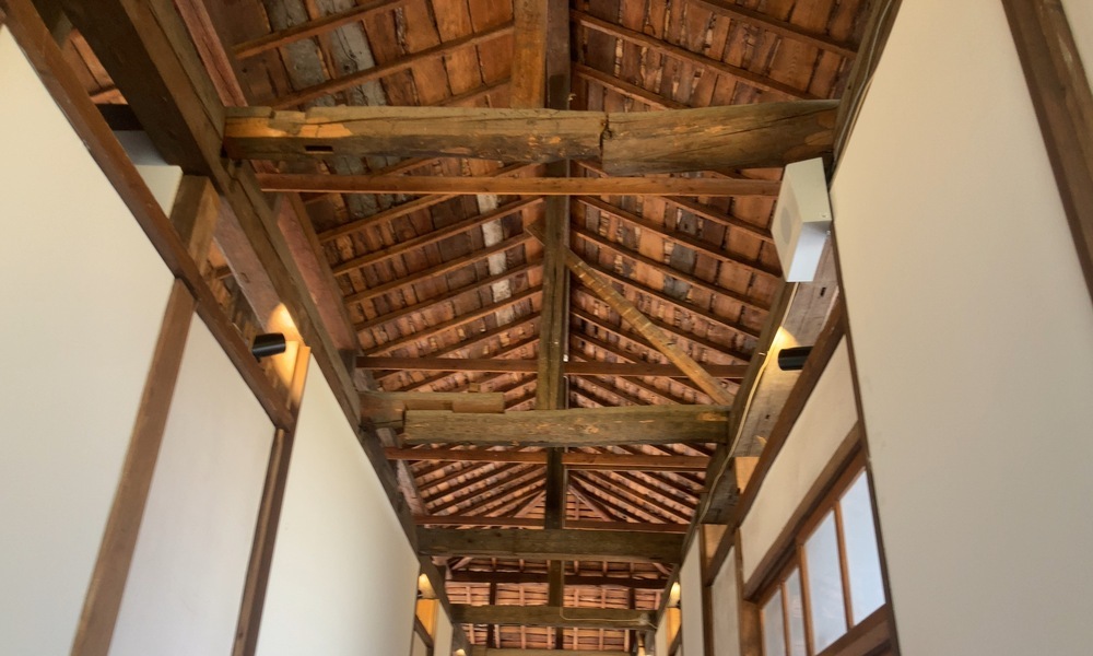 エプソンミュージアム諏訪・創業記念館の屋根構造を見上げた内部写真。木組みが時代の面影を伝える。